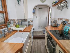 a kitchen with a sink and a counter top at Cockle Bay Cottage in Morecambe