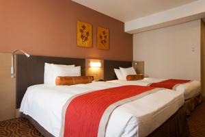Postel nebo postele na pokoji v ubytování Hotel Sardonyx Tokyo