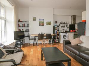 a living room with a couch and a table at Cherrywood Manor in Bodmin