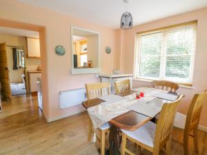 a dining room with a table and chairs at Dyfi Cottage in Machynlleth