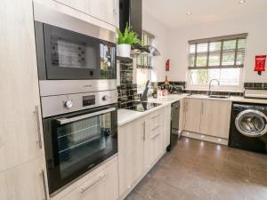 a kitchen with a sink and a stove top oven at 2 Ings Avenue in Settle