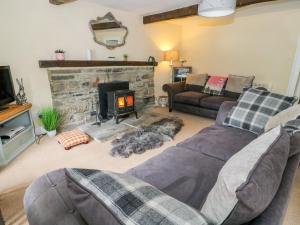 a living room with a couch and a fireplace at Church Farm Cottage in Skipton