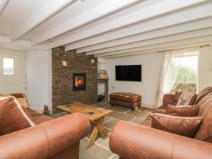 a living room with couches and a fireplace at The Aspens in Barnard Castle