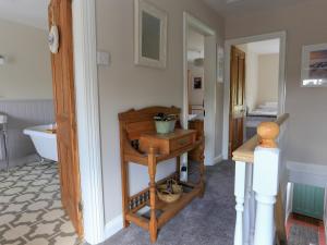 a bathroom with a wooden table and a sink at Moelwyn View Cottage in Blaenau-Ffestiniog +18 photos