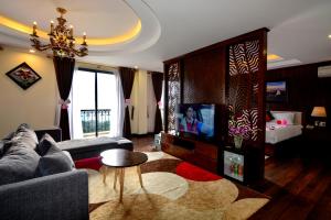 a living room with a couch and a tv at The View Sapa Hotel in Sa Pa