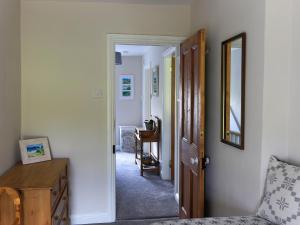a hallway with a mirror and a chair in a room at Moelwyn View Cottage in Blaenau-Ffestiniog