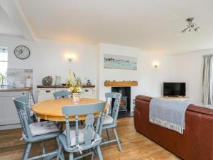 a kitchen and dining room with a table and chairs at Church Gate Cottage in Beaumaris