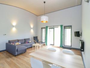 a living room with a couch and a table at Foxglove in Glastonbury