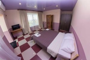 a bedroom with a bed and a checkered floor at Maldives in Vapnyarka