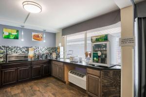 a large kitchen with a counter with a microwave at Quality Inn Concord Kannapolis in Concord