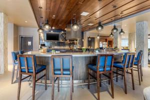 
a kitchen with a dining room table and chairs at Cambria Hotel Milwaukee Downtown in Milwaukee
