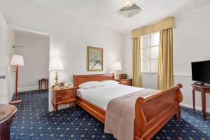 a hotel room with a bed and a television at Castlereagh Boutique Hotel, an Ascend Collection Hotel in Sydney