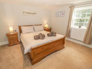 Ένα ή περισσότερα κρεβάτια σε δωμάτιο στο Bryn Derwen Coach House