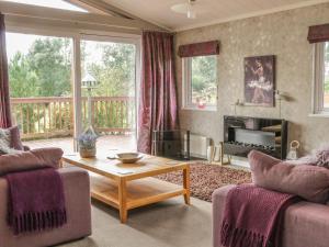 a living room with a couch and a coffee table at Bulmer Farm Lodge in Malton
