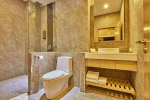 a bathroom with a toilet and a sink at Serenity Hotel and Spa Kabinburi in Kabin Buri