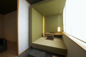 a room with a small table and a window at hotel kanra kyoto in Kyoto