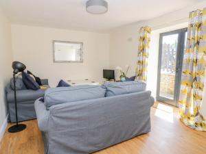 a living room with a couch and a table at Puddleducks in Sherborne