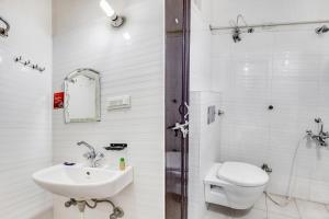 a bathroom with a sink and a toilet and a shower at FabHotel Himanshi in Udaipur