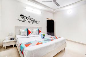 a bedroom with a large bed in a room at FabHotel Himanshi in Udaipur