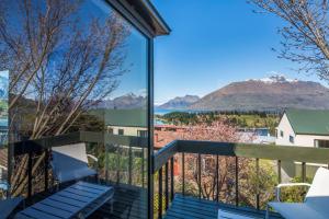 a balcony with a view of the mountains at Panoramic: farmhouse theme with shared spa pool in Queenstown