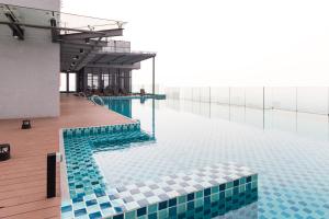 a swimming pool with blue and white tiles on a building at Eko Cheras Premium Suite in Kuala Lumpur