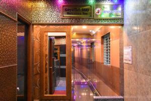 a hallway of a building with a mirror and lights at Gayathri Stay in Kanchipuram