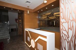 a lobby with a counter in a building at Hotel Vagmi in Varanasi