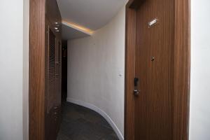 a hallway with a wooden door in a room at Hotel Vagmi in Varanasi +8 photos