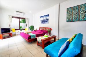 a living room with a couch and a table at ABC Apartment Sanur in Sanur