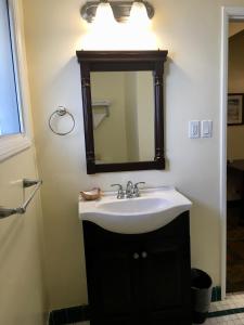 a bathroom with a sink and a mirror at Los Feliz Hotel in Glendale