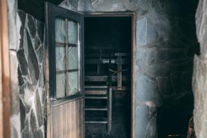 an open door into a room with a ladder at Ruka Peak - Boutique Hotel & Restaurant in Ruka