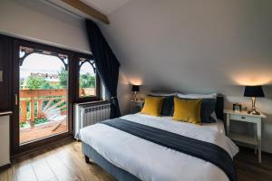 a bedroom with a bed and a large window at Domek u Bronka in Białka Tatrzanska