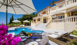 a villa with a swimming pool and a house at Holiday Villa Port d'Andratx in Port d'Andratx