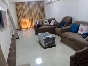 a living room with two couches and a coffee table at Alexandria princess in Alexandria