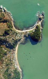 an aerial view of a beach with boats in the water at Cabaña Coliumo Tomé in Dichato
