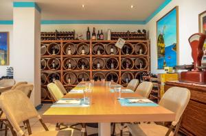 comedor con mesa, sillas y estantes para vinos en Hotel Resort Marinella, en Gabicce Mare