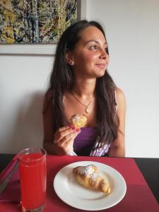 a woman sitting at a table with a plate of food at Hotel Nuvò in Naples