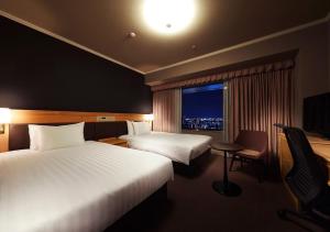 Rúm í herbergi á Hotel Agora Regency Osaka Sakai