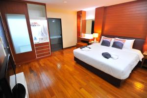 a bedroom with a large white bed in a room at 42Grand Residence in Bangkok