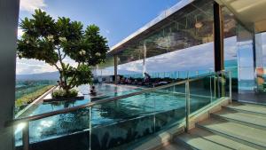 a house with glass walls and a swimming pool at The Astra,City center,Best view,Big room,5mins,Night Market in Chiang Mai