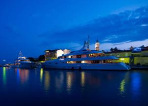 two boats are docked in a harbor at night at Apartman Jadranka in Rab