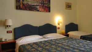 Postel nebo postele na pokoji v ubytování Hotel Altavilla Dieci