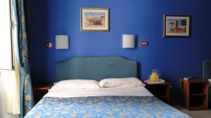 Postel nebo postele na pokoji v ubytování Hotel Altavilla Dieci