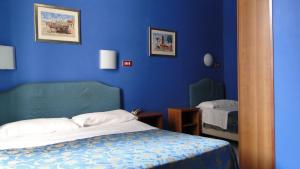 Postel nebo postele na pokoji v ubytování Hotel Altavilla Dieci
