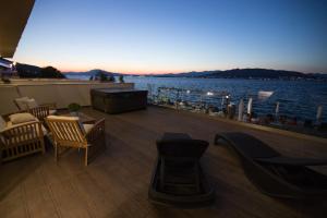 a balcony with chairs and a view of the water at Aianteion Bay Luxury Hotel & Suites in Aiándion