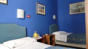Postel nebo postele na pokoji v ubytování Hotel Altavilla Dieci