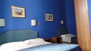 Postel nebo postele na pokoji v ubytování Hotel Altavilla Dieci