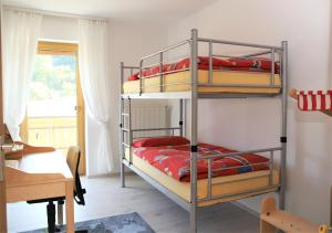 a bedroom with two bunk beds with red pillows at Ferienwohnung Röhrer in Obertrubach