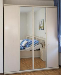 a bedroom with a closet with a bed inside at Ferienwohnung Röhrer in Obertrubach
