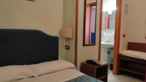 Postel nebo postele na pokoji v ubytování Hotel Altavilla Dieci
